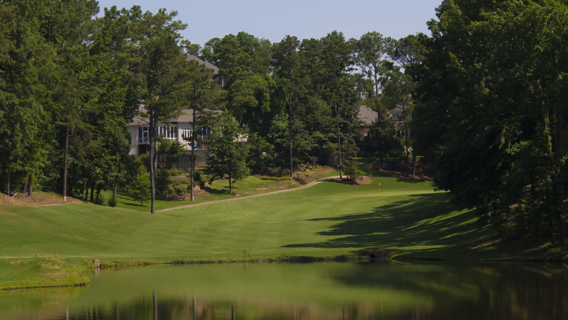 Image of golf ball on tee on grass.